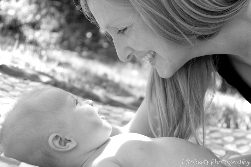 B&W mother talking to baby - baby portrait photography